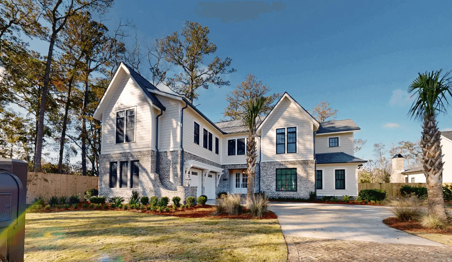 Large suburban two-story home and palm.