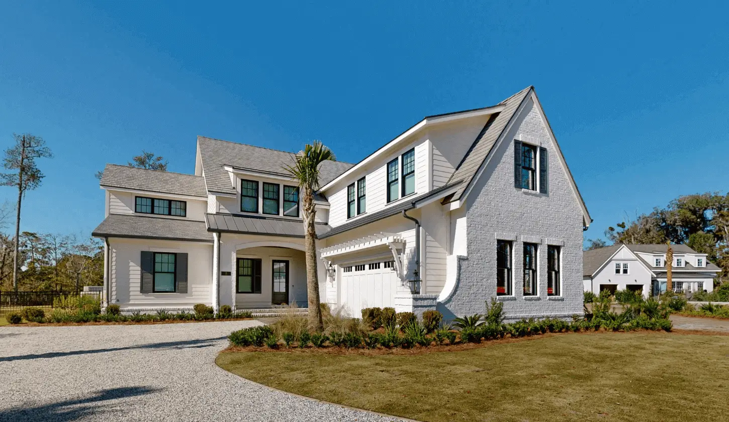 Large gabled home with landscaped front yard.