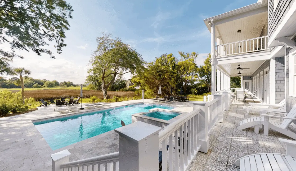 Modern pool and hot tubs next to house.
